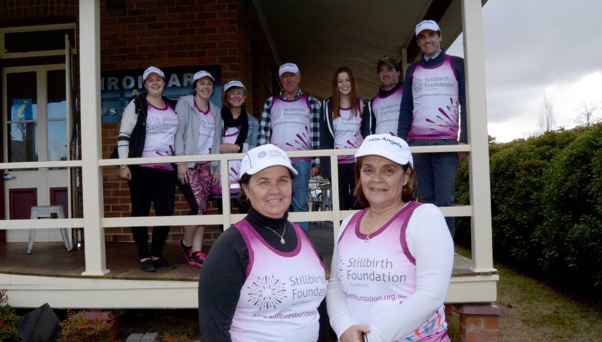 Big support: Kathy Fardon and Cheryl Toohey, with family and friends behind, have raised nearly $25,000 for the Stillbirth Foundation. Photo: Mark Logan.