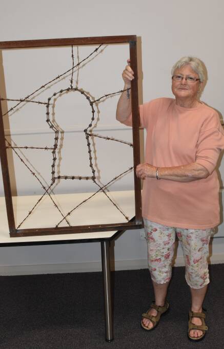 Loretta Kervin with Lachlan Price's sculpture 'Lock, stock and barrel.'