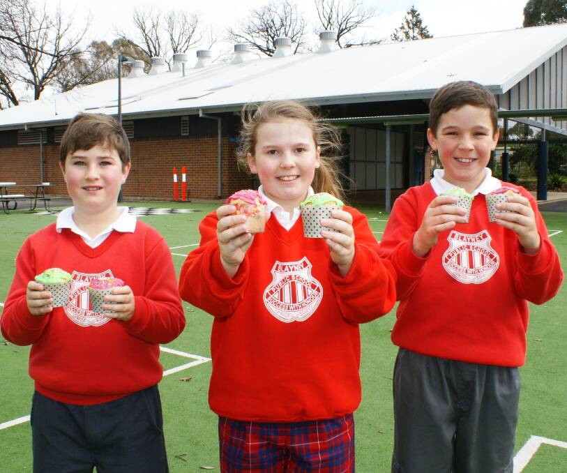 Hard choices: Toby Tyrell, Evvie Buesnel and Jack Miskell with some of the delights that will be on offer at Blayney Public School during Saturday's poll.