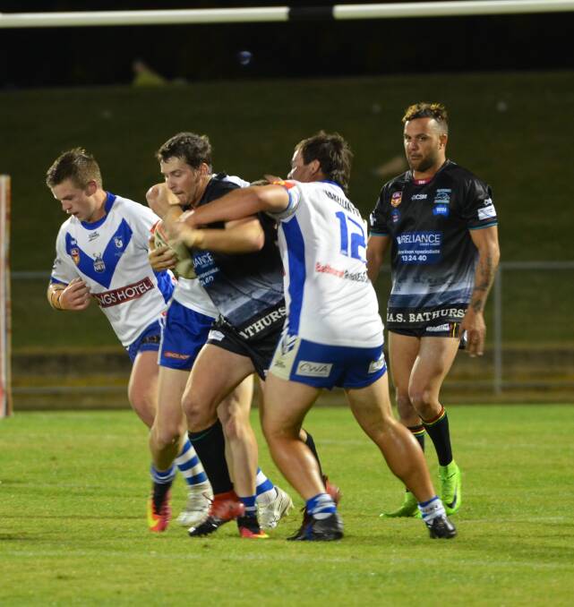 BIG EFFORT: The Saints' defence brings Panthers centre Jye Barrow to a halt at Carrington Park on Friday night. The Saints led 10-0 before fatigue set in. Photo: ANYA WHITELAW 042117yderby46