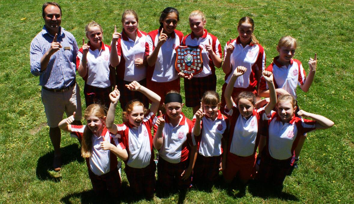 WE ARE THE CHAMPIONS: The Primary Schools Sports Association girls cricket champions, Blayney Public School, celebrate their victory at school on Wednesday. Photo: MARK LOGAN