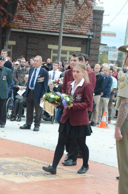 Wet weather was not enough to keep school students, returned servicemen and women and other community members from taking part in the Anzac Day service at Blayney on Tuesday. Photos: GRANT HATCH