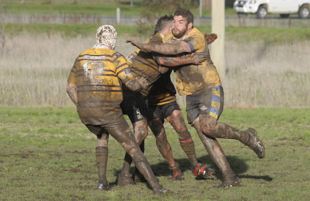 MUDDY GAME: CSU Mungoes' Brendan Bartlett takes on the Portland Colts defence in his side's 26-22 win on Saturday. Photo: CHRIS SEABROOK 072316csu