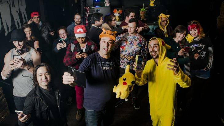 Reload Bar owners Ravi Sharma and Jim Andrews (centre) are banking on the success of Pokemon Go by planting lures and offering themed events, including a Pokepartybus. Photo: Jamila Toderas