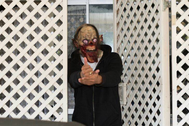 A man dressed in a monster mask comes out of Rose Corby's home, mother of Schapelle Corby, in the suburb of Loganlea, the morning after the return of Schapelle Corby from deportation from Bali. Photographed Sunday 28th May 2017. Photograph by James Brickwood. SMH NEWS 170528