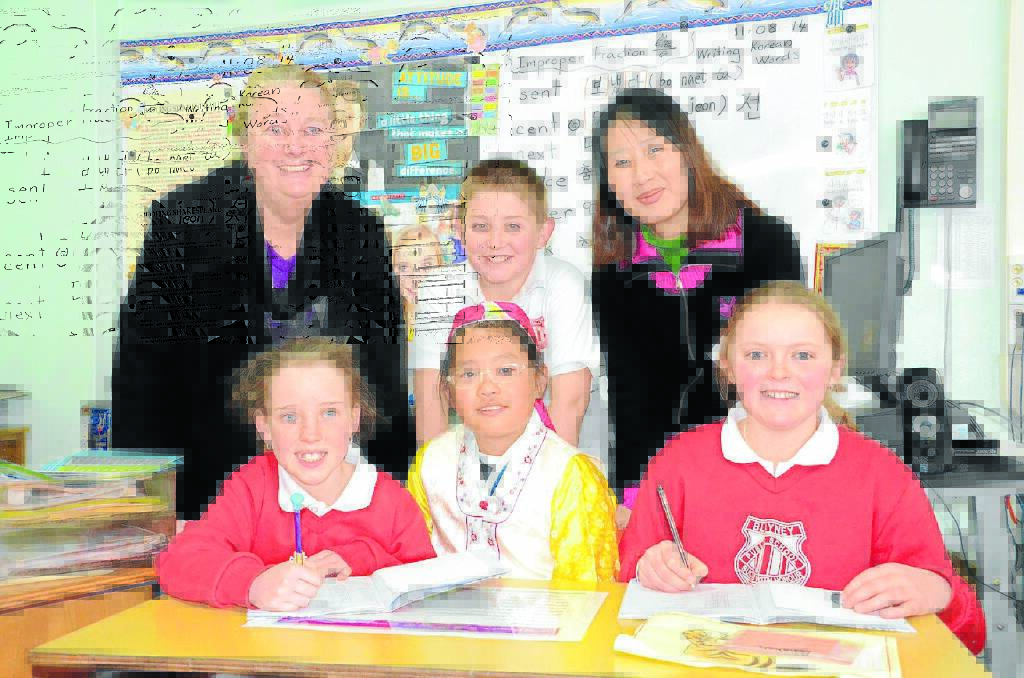 With the help of BRIDGE teachers Lilly Hatch and Woo Hyunju and Ms Woo's daughter Shin Joohei (front centre), Blayney students Hayley Apfel, Jacob Dorsett and Rebekah Hilliard are already writing and speaking some Korean.