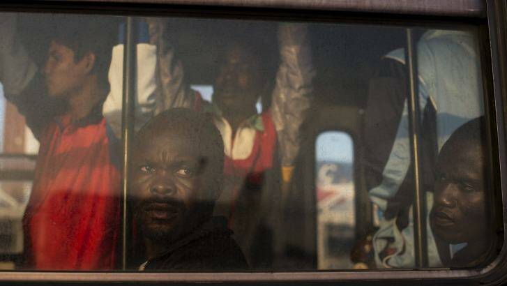 Perilous voyage: Refugees from Nigeria and Ghana wait on a bus to be taken to temporary accommodation after arriving to Sicily. Photo: New York Times