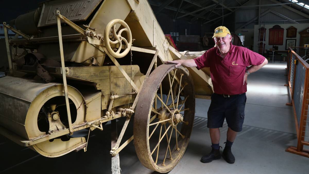 GOLDEN MEMORIES: Millthorpe and District Historical society volunteer Peter Amos with an 1884 Sunshine stripper harvester which will feature in the Trevor Pascoe museum. Photo: PHIL BLATCH