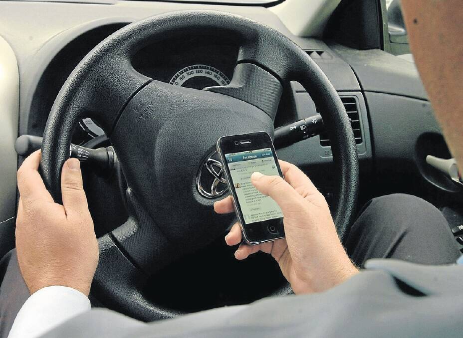 Tougher penalties are being introduced for mobile phone use whilst behind the wheel. Photo: STEVE GOSCH. 