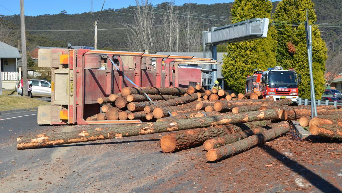 TRUCK ACCIDENT: The logging truck's cargo spilled onto the streets.