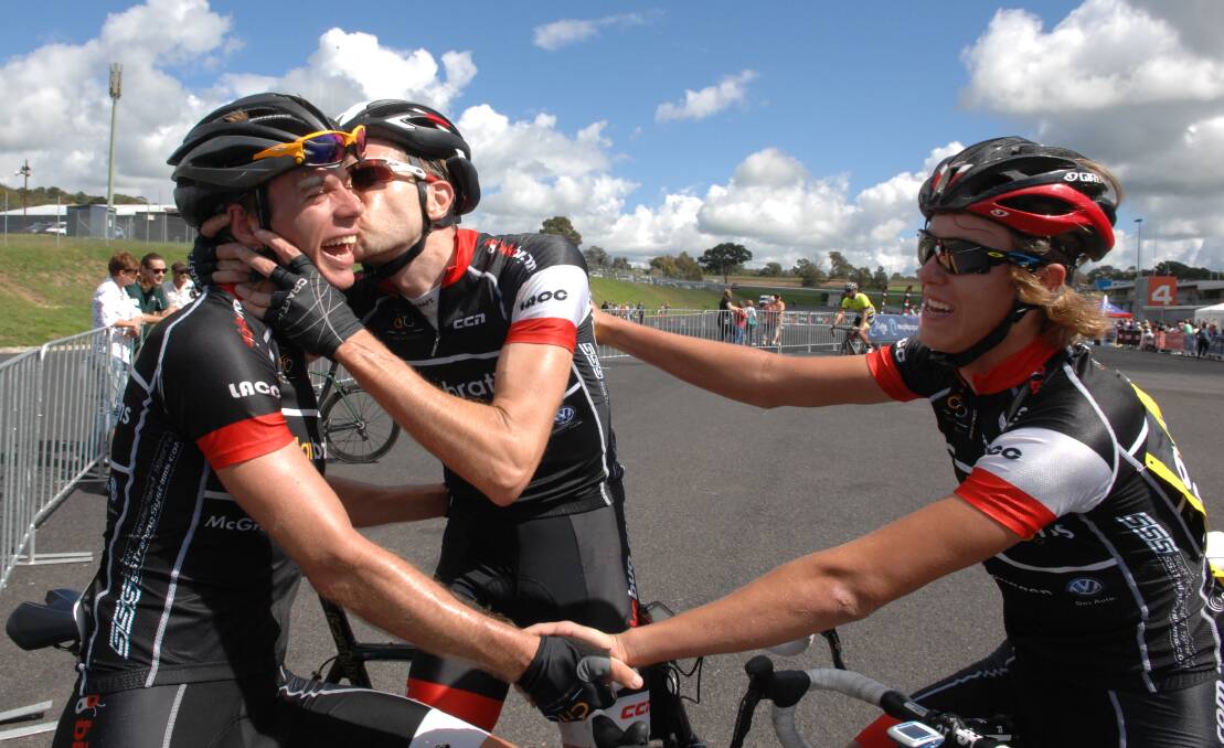 SMOOCH: Blayney to Bathurst winner Josh Berry receives a celebratory kiss from a teammate after taking out overall honours on the long course in Sunday's race. 
Photo: ZENIO LAPKA 040614zcyclo81