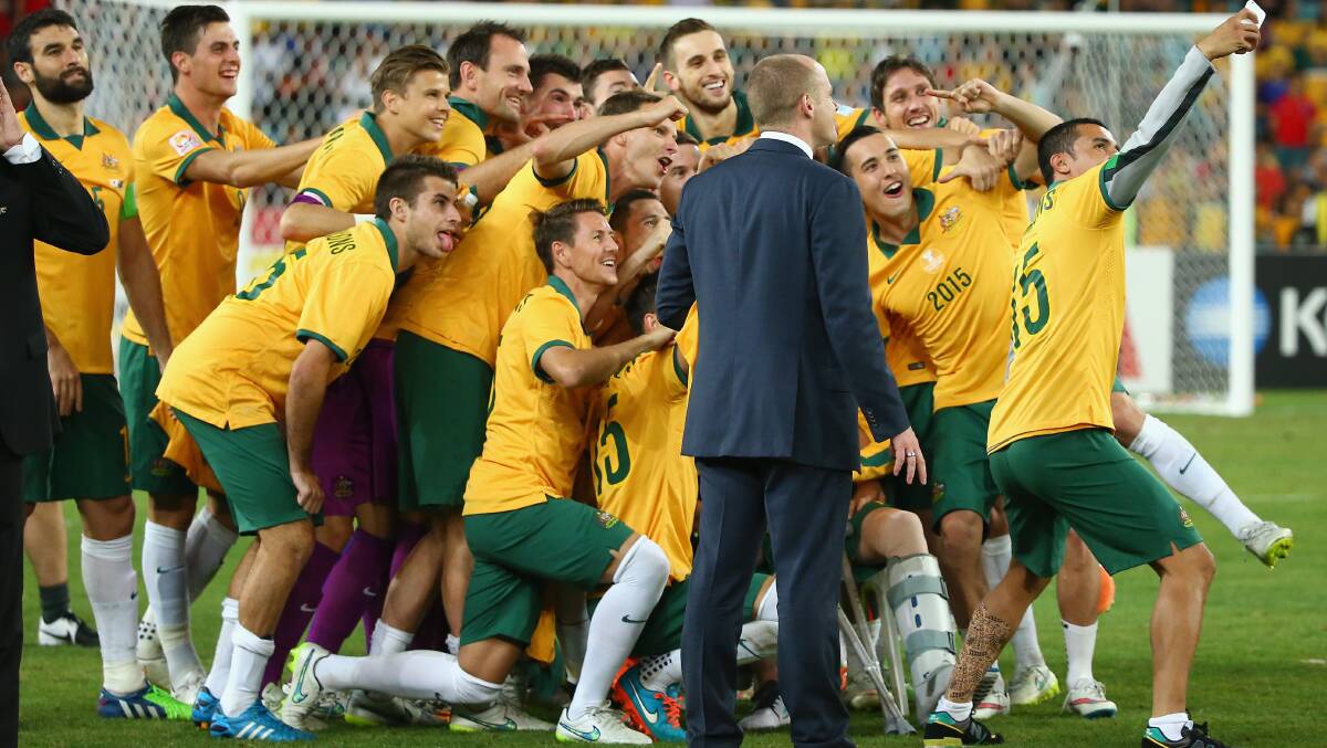 SUPER SELFIE: Tim Cahill (right) takes a selfie with the Socceroos squad, including Blayney's Nathan Burns (kneeling centre) after winning the 2015 AFC Asian Cup. Photo: GETTY IMAGES