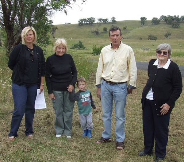 Patina Schneider, Maureen Campbell, Harry Nagy, John Foster, and Marie Burton near Errowanbang Public School, which they believe, is at risk of closure if a wind farm proposed at Flyers Creek is approved. Photo: Clare Colley.