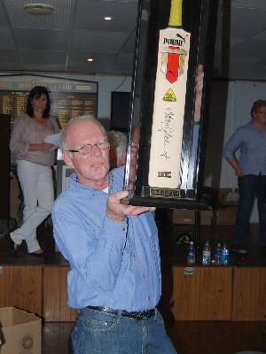GENEROUS DONATION: Paul Sligar proudly holds aloft his Adam Gilchrist autographed bat that proved to be one of the most hotly contested items at the auction.