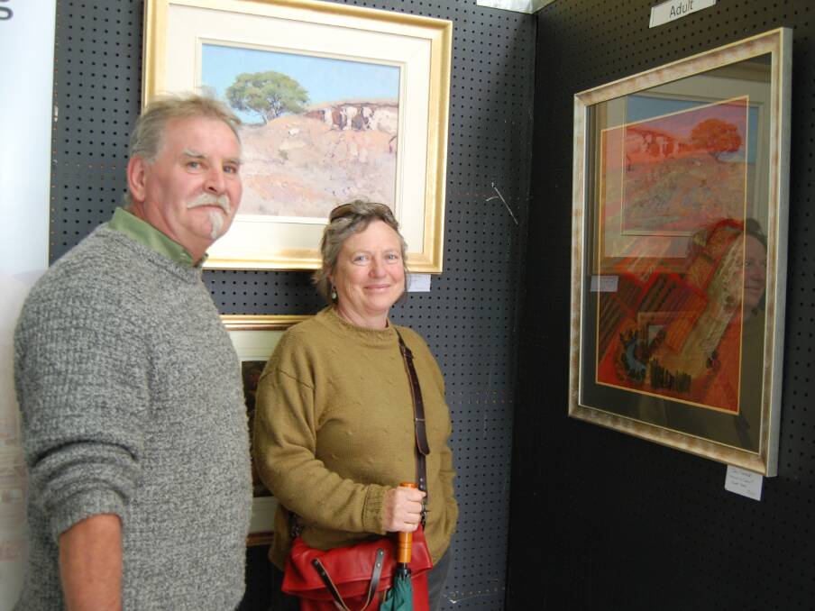 Roy Senior and Nancy Gordon admire some of the wonderful art entries in the Blayney Festival competition.  Photo: Wayne Cock.