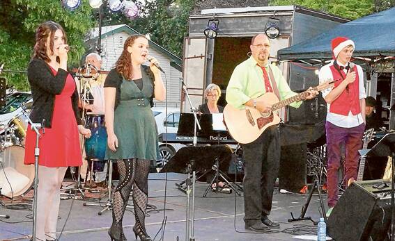 Erinn Rimmer, Aislee Rimmer, Rv. Andrew Parkinson and Josh Cheney perform at Carols in Carrington on Friday night. Photo: Wayne Cock.