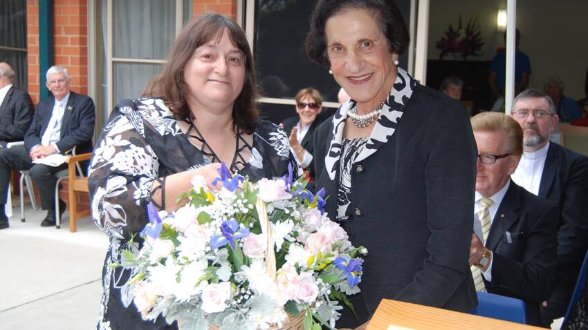 Uralba board secretary, Gail Blowes presents Her Excellency, Marie Bashir with a beautiful basket of flowers at the opening of the new wing.  Photo: Wayne Cock.