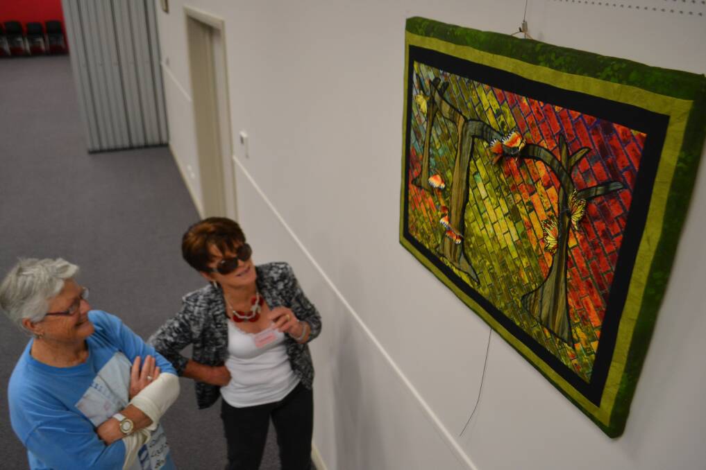 Loretta Kervin and Cecily Walters admire an entry in the innagural Textures of One exhibition.