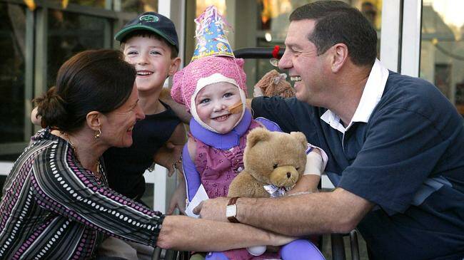 Sophie Delezio leaving The Children's Hospital in Westmead in 2004 with her brother, Mitchell, and parents, Ron and Carolyn, six months following the horrific incident at her Fairlight daycare centre in Sydney. Picture by Steven Siewert via AAP.