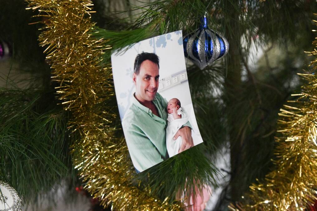 Daniel Duggan on the family Christmas tree. Picture by Carla Freedman
