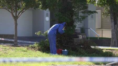 Police on scene at Karoola Road, Lambton photographing the contents of a bucket. Picture by Marina Neil 
