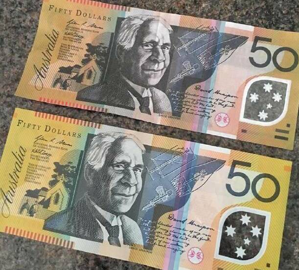 DODGY NOTES: Fake $50 notes were circulated in Orange earlier this year. The darker note at the top is the counterfeit.
