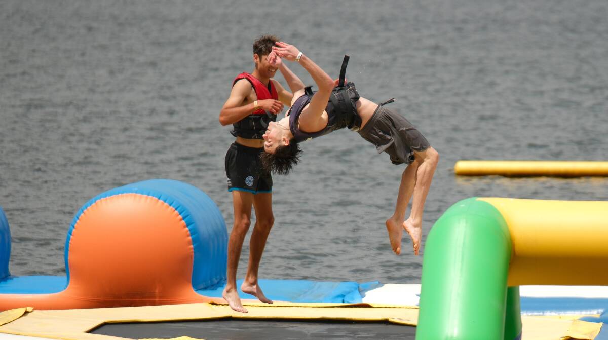 Teen backflipping on the equipment at the Bathurst Aqua Park on November 26, 2023. Picture by James Arrow