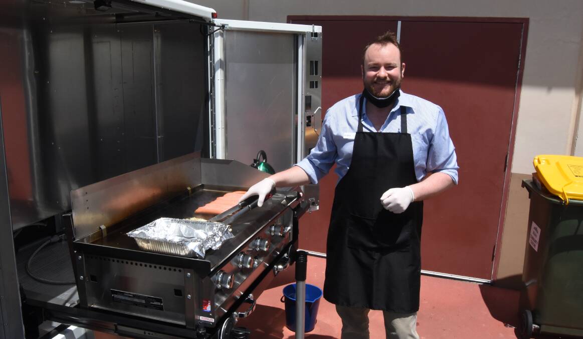 Hot stuff: Lifeline Crisis Support person and barbecue master Greg Jeffree debuting his cooking skills and the new barbecue. Photo: Mark Logan.