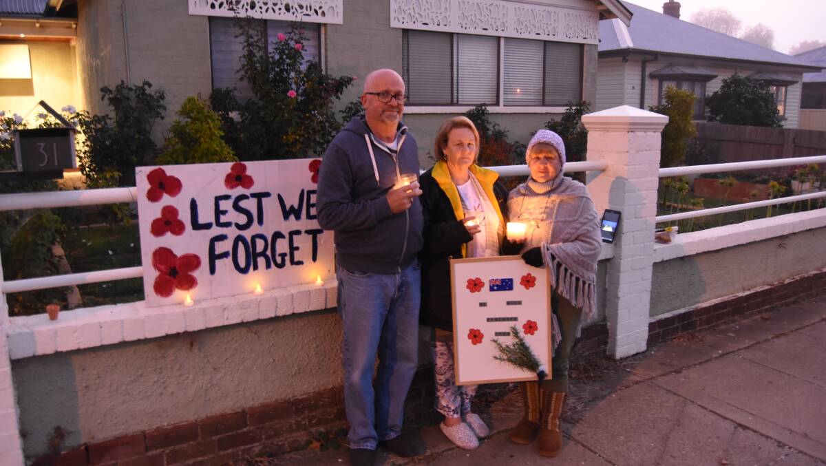 STREET VIGIL: Stephen and Terese Carey and Cheryl Mann outside their Water Street home on ANZAC Day in 2020. Photo: Mark Logan.