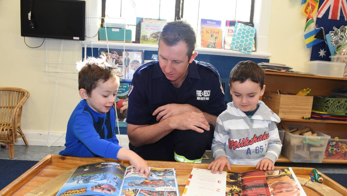 Safe advice: Blayney brigade member Dustin Burns, with Xavier and Angus, check out some fire safety advice at Blayney Early Learners.