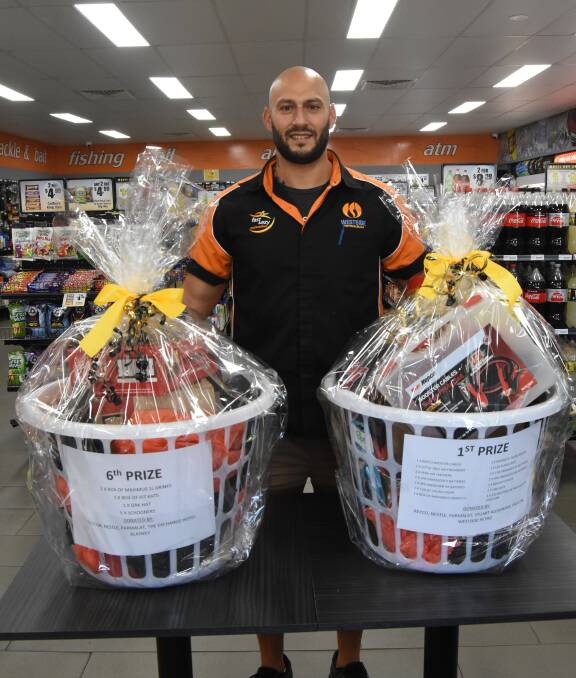Perfect combo: Westside Petroleum Manager Richard Makhlouf with two of the baskets that will be raffled off at this Saturday's sausage sizzle fundraiser.