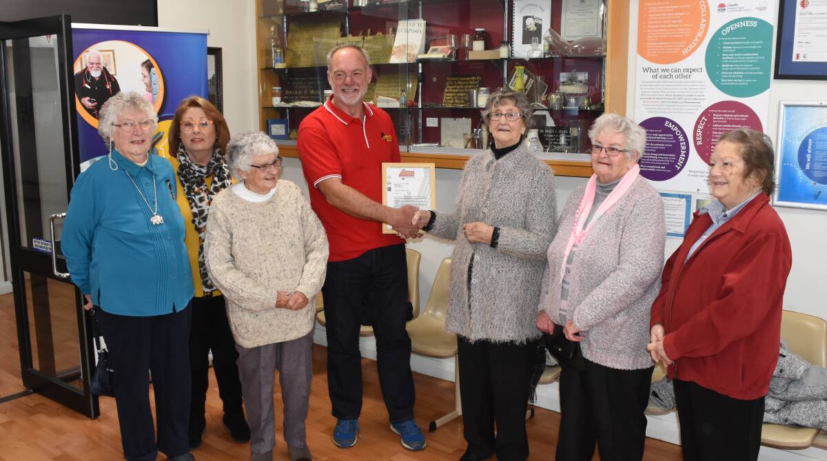 4WD donation: Lola Wyatt, Tracey Wilkinson, Fay Redhead, Judy Cook, Shirley Cox and Kathy Roach receiving a cheque from Andrew Lockley.