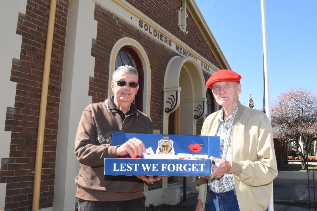 AN HONOUR: Reg Rendell and Peter Sutton will be selling Legacy badges outside Bernardi's from Thursday to Saturday.
