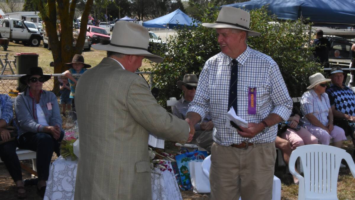 MEDAL WINNER: Phil Nankivell receiving a RAS service medal from RAS councillor Michael Millner in 2019. Photo: Mark Logan.