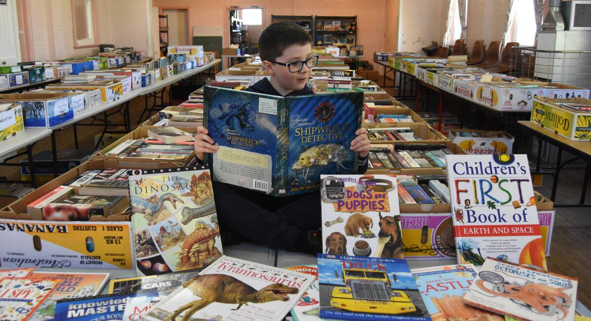 GOOD BOOK FACE: Henry Power was fascinated by the book Shipwreck Detective during a sneak peak of the Blayney Anglican Parish Book Fair. Photo: Mark Logan.