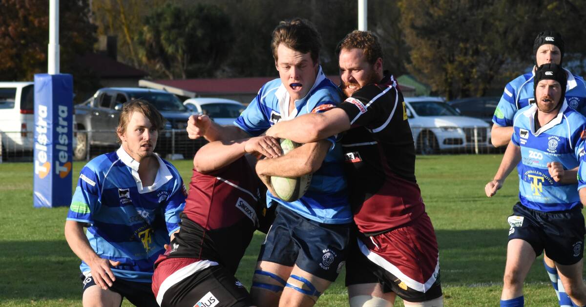 Captain crunch: Baz Hobby gets smothered by two Boars players on Saturday. Rams are away to CSU Bathurst this week followed by a home game on the 26th May against Dubbo Rhino's. Photo: Mark Logan.