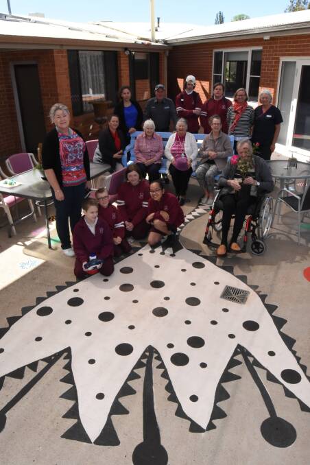 Opening up: Students from Blayney High School and residents and staff from Lee Hostel with part of the new painting. Photo: Mark Logan.