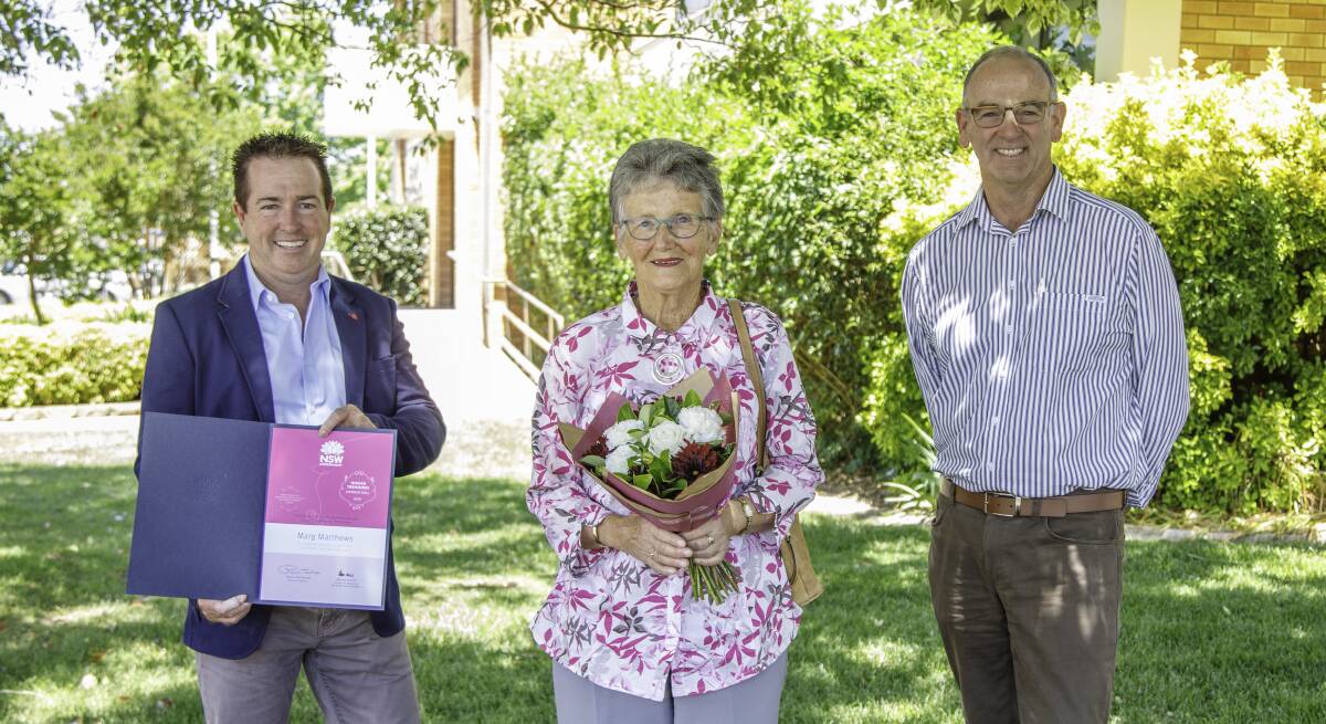 Honoured: Member for Bathurst Paul Toole and Blayney Mayor Scott Fergus, caught up with Ms Matthews in Blayney to present her with a special certificate and posy of flowers. Photo: Contributed.