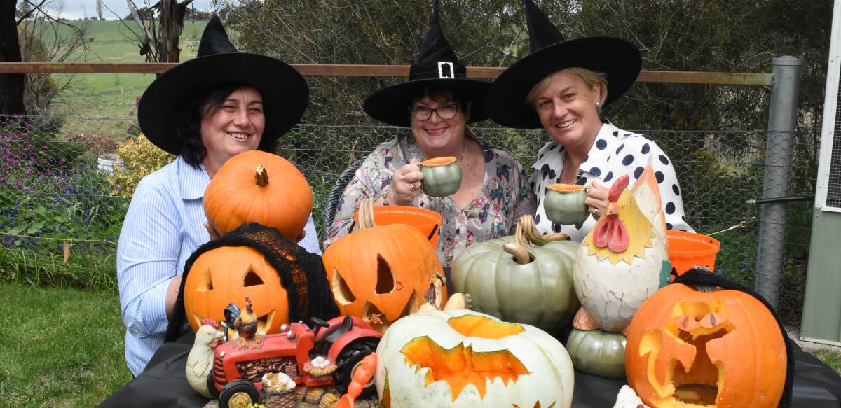 Spooky: Bonnie Perkins, Jane Whitten and Karen Somervaille were carving up a storm in preparation for Sunday's farmers market.