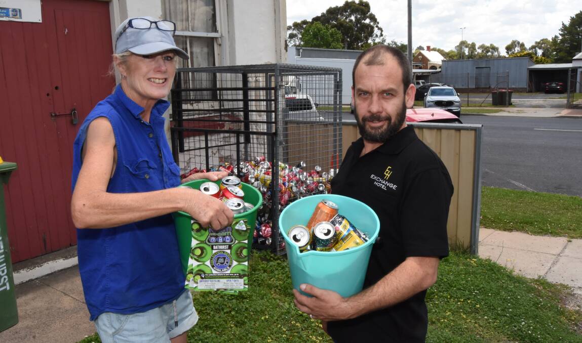 Can the can: Chris Clark from Return and Earn Bathurst with Marty Russell near the can  collection area at the rear of the Exchange Hotel. Photo: Mark Logan.