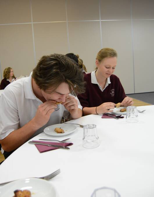 Digging in: Ryan Hunter and Kimmy Anderson were keen to indulge in their etiquette lunch. Photo: Mark Logan