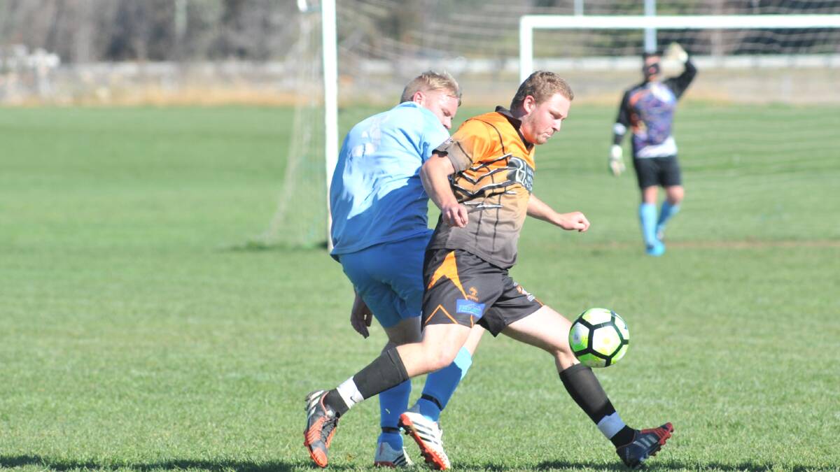 IN ACTION: Dangerous Millthorpe Tigers forward Jono McCann takes possession of the football during a match last season, as the Tigers charged late to win the title. 