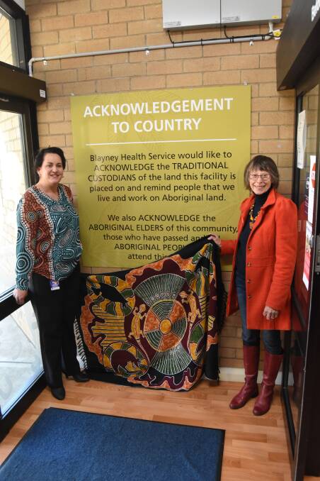 Warm welcome: Amanda Byrnes and Nyree Reynolds unveiling the acknowledgement of country sign. Photo: Mark Logan.