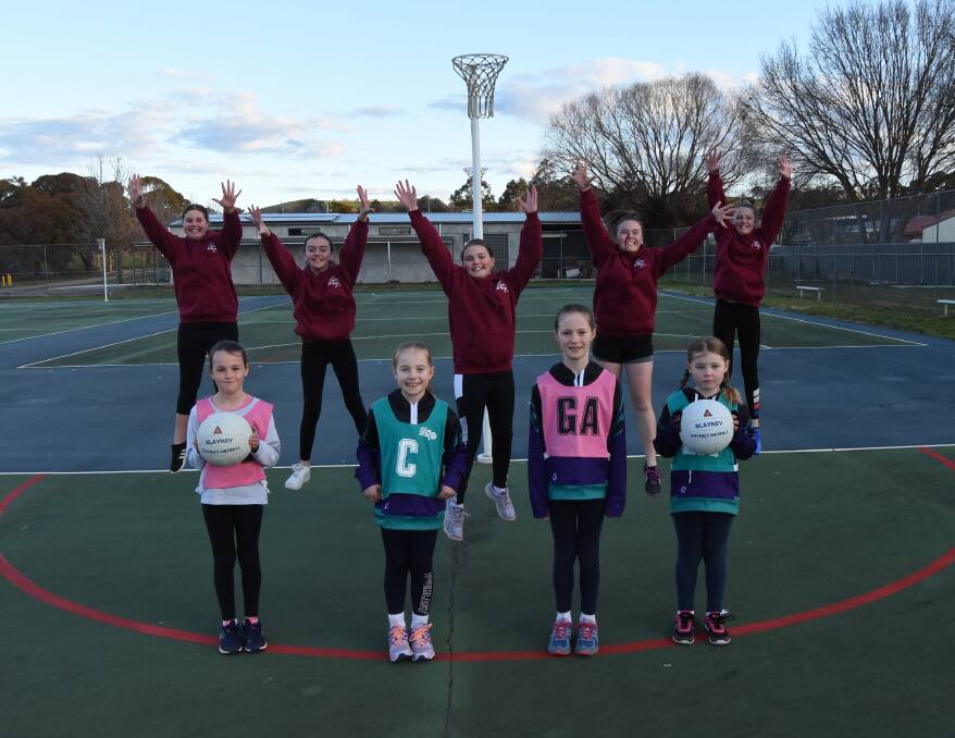 All smiles: Seniors players Maddison, Lauren, Molly, Evvie and Ruby with (front) Grace, Eve, Grace and Daisy on the soon to be replaced netball courts. Photo: Mark Logan.