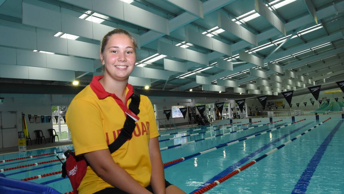 LIGHT AND QUIET: Lifeguard Caitlyn Nobbs at the diving end of the pool with the new roof including hanging sound baffles and skylights behind her. Photo: Mark Logan.