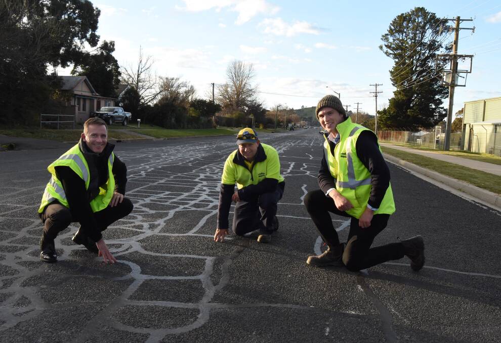 ROUGH LOOK: Blayney Shire Council staff Charlie Harris, Col Hewitt and Ben Prestwidge examining the surface of Carcoar Street. 