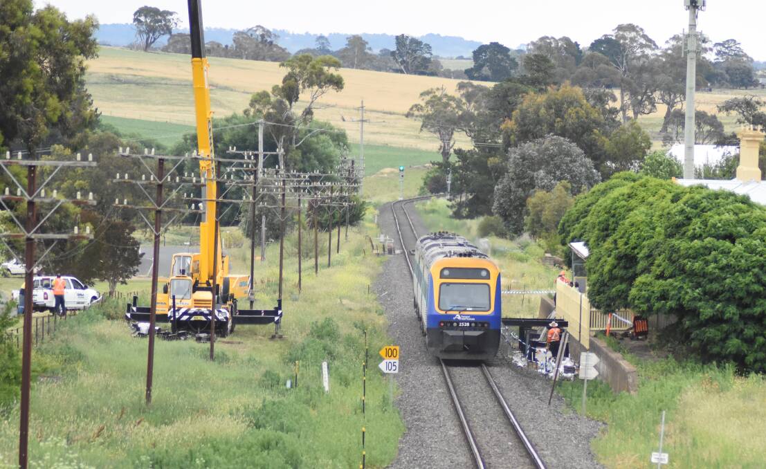Perfect fit: The Dubbo bound XPT passing by the first of the platform extensions lowered into place. Photo: Mark Logan.