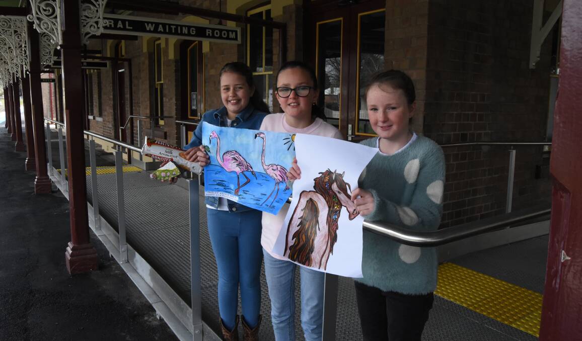 CREATIVE: Amara Ryan, Matilda Miskell and Bella Miskell with some of their work outside the Platform Arts Hub.