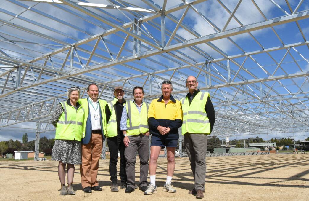 Cover up: Rebecca Ryan, Grant Baker, Charlie Harris, Paul Toole, Ian Reeks and Scott Ferguson under the roof of the new equestrian centre. Photo: Mark Logan.