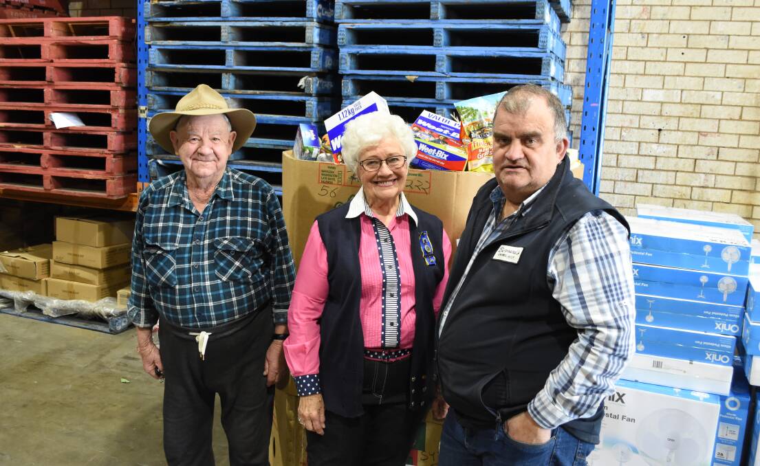 Helping out: Don Bell, past state president of the CWA Audrey Hardman OAM and Geoff Bottom with some of the $2,400 worth of goods donated by the public. Photo: Mark Logan.